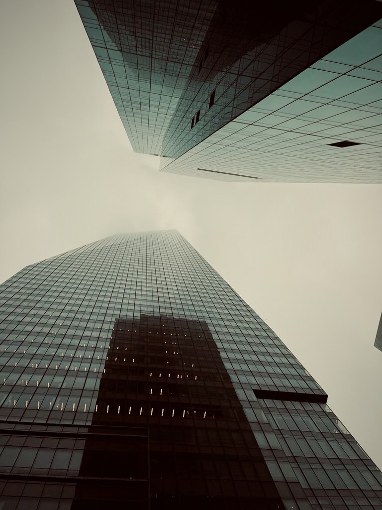 Glass skyscrapers disappearing into fog