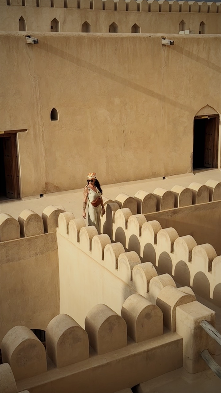 Cristiana on the crenellated walls of a fort
