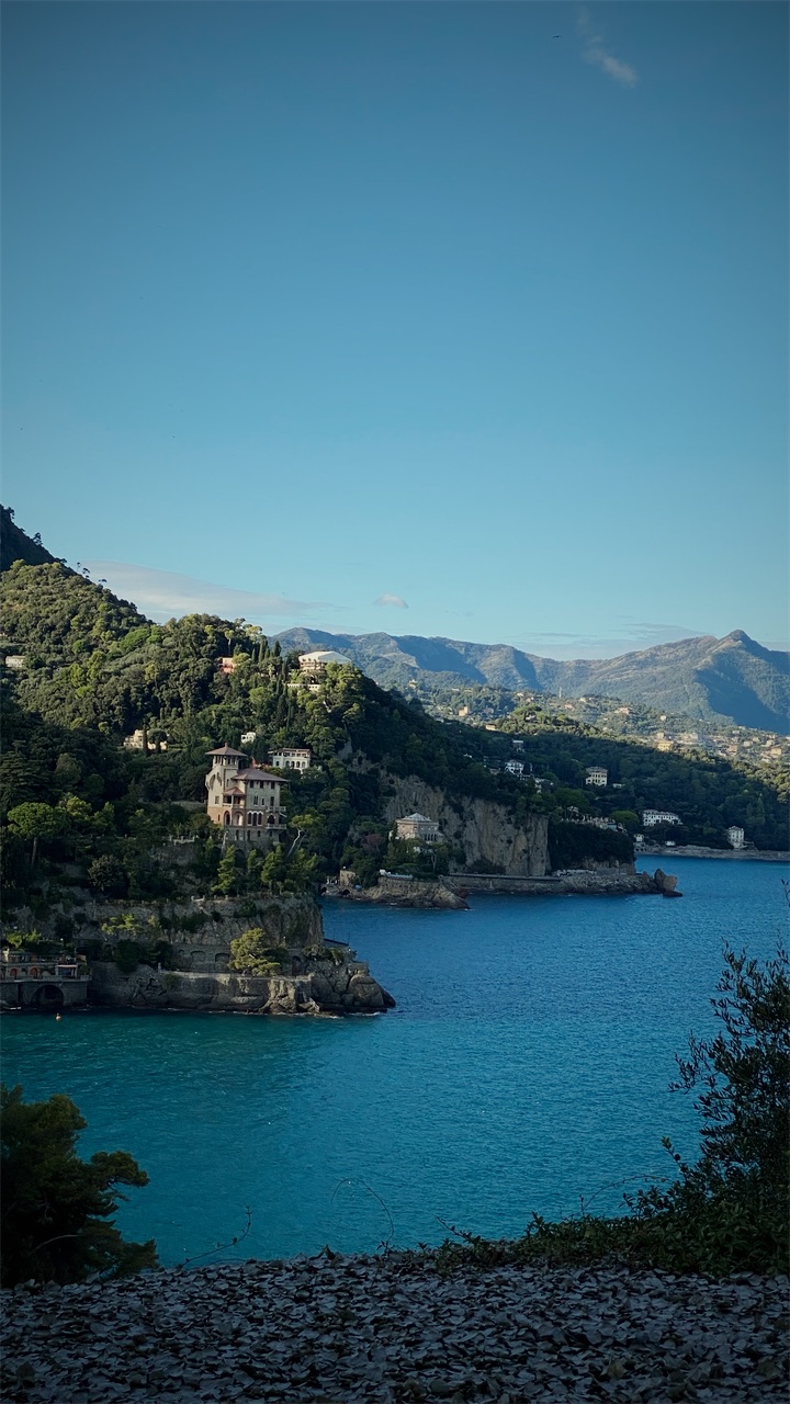A turquoise bay below a wooded headland